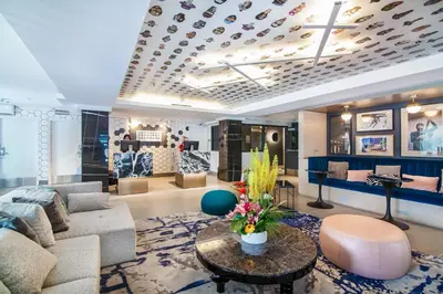a living room with a couch and a table at Hotel Belmont Vancouver - MGallery Collection in Vancouver