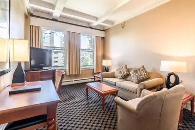 a living room with a couch and a table at The Sylvia Hotel in Vancouver