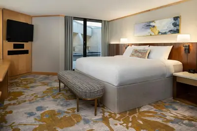 a hotel room with a bed and a television at Metropolitan Hotel Vancouver in Vancouver