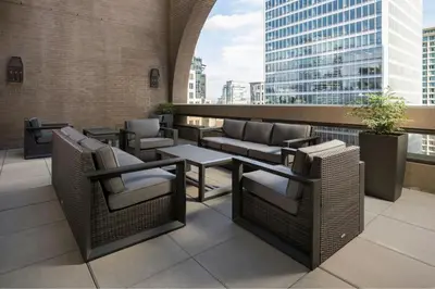 a patio with chairs and tables on a building at Metropolitan Hotel Vancouver in Vancouver