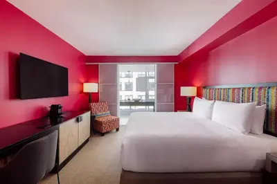 a hotel room with a large bed and a tv at OPUS Vancouver in Vancouver