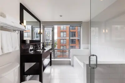 a bathroom with a sink and a toilet and a shower at OPUS Vancouver in Vancouver