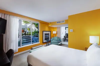 a hotel room with a bed and a large window at OPUS Vancouver in Vancouver