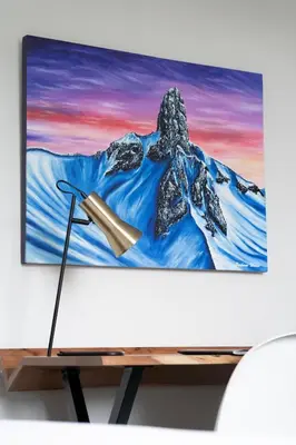 a tv on a table with a picture of a mountain at Adara Hotel in Whistler