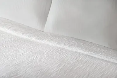 a close up of a white bedsheet at La Quinta Inn by Wyndham Vancouver Airport in Richmond