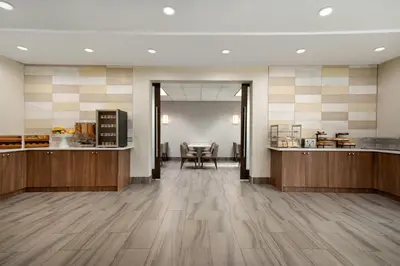 a lobby with a table and chairs in a building at La Quinta Inn by Wyndham Vancouver Airport in Richmond