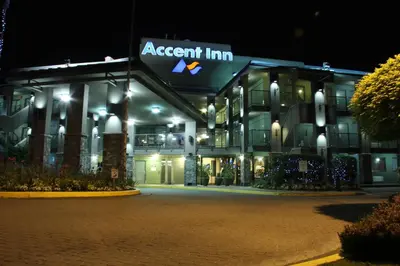 a apartment building at night with a sign on it at Accent Inns Vancouver Airport in Richmond