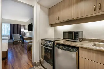 a kitchen with a microwave and a sink in a room at Days Inn by Wyndham Victoria On The Harbour in Victoria