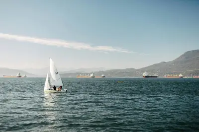a small sail boat in a large body of water at Delta Hotels by Marriott Vancouver Downtown Suites in Vancouver