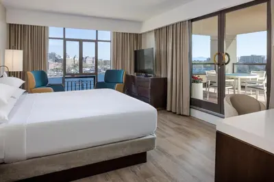 a hotel room with a bed and a dining area at Delta Hotels by Marriott Victoria Ocean Pointe Resort in Victoria