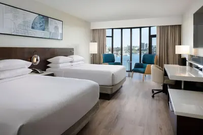a hotel room with two beds and a desk at Delta Hotels by Marriott Victoria Ocean Pointe Resort in Victoria
