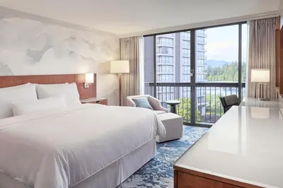 a hotel room with a bed and a large window at The Westin Bayshore, Vancouver in Vancouver