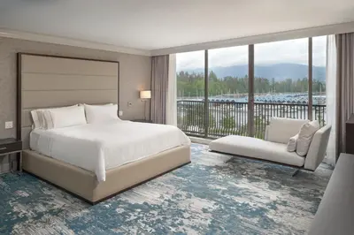 a bedroom with a large bed and a balcony at The Westin Bayshore, Vancouver in Vancouver