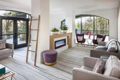 a living room with couches and a fireplace at The Westin Bear Mountain Resort & Spa, Victoria in Victoria