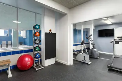 a room with a gym with a red ball and a treadmill at Days Inn by Wyndham Victoria Uptown in Victoria