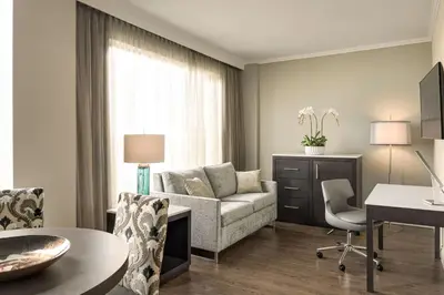 a living room with a couch and a table at Georgian Court Hotel, WorldHotels Elite in Vancouver
