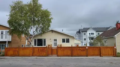 a wooden fence in front of a house at YK Aurora in Yellowknife