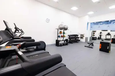 a gym with several treadmills and exercise bikes at DoubleTree by Hilton Calgary North in Calgary