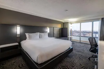 a hotel room with a large bed and a large window at DoubleTree by Hilton Calgary North in Calgary
