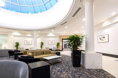 a lobby with a domed ceiling with couches and chairs at DoubleTree by Hilton Calgary North in Calgary