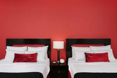 two beds in a red room with red walls at Moda Hotel in Vancouver