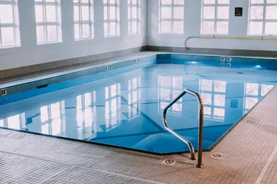a large swimming pool with a hand rail in it at Coast Canmore Hotel & Conference Centre in Canmore
