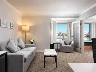 a living room with a couch and a table at Hotel Grand Pacific in Victoria