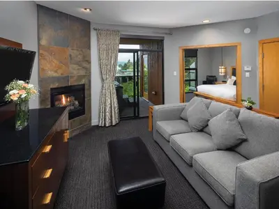 a living room with a couch and a fireplace at Brentwood Bay Resort & Spa in Brentwood Bay