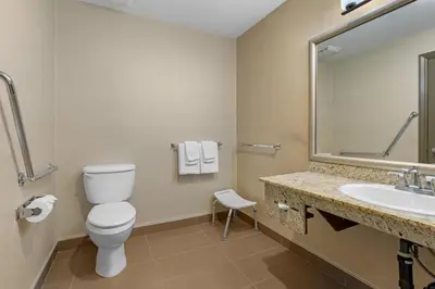 a bathroom with a toilet and a sink at Best Western King George Inn & Suites in Surrey
