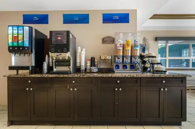a kitchen counter with a coffee maker on it at Best Western King George Inn & Suites in Surrey