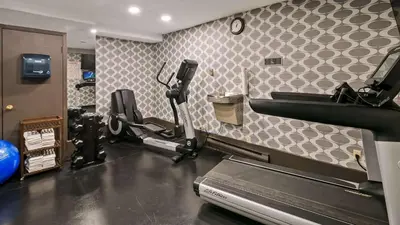 a room with a gym with a treadmill at Best Western Airport Inn in Calgary