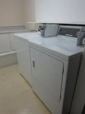 a kitchen with a white counter and a dishwasher at Cassandra Hotel in Vancouver