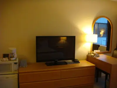 a television on a dresser in a hotel room at Cassandra Hotel in Vancouver