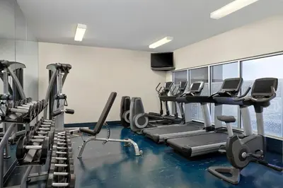 a gym with treadmills and cardio machines at Four Points by Sheraton Hotel & Suites Calgary West in Calgary