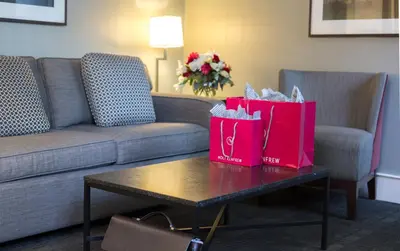 two shopping bags on a coffee table in a hotel room at The St. Regis Hotel in Vancouver