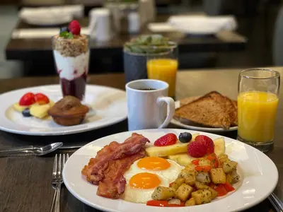 two plates of breakfast food with eggs bacon and toast at The St. Regis Hotel in Vancouver