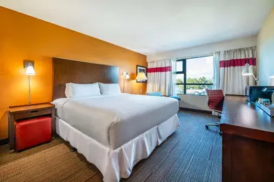 a hotel room with a large bed and a desk at Grand Park Hotel Vancouver Airport, an Ascend Collection Hotel in Richmond