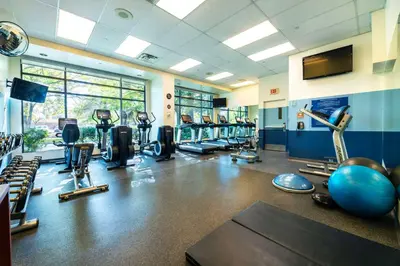 a gym with a lot of treadmills and machines at Grand Park Hotel Vancouver Airport, an Ascend Collection Hotel in Richmond