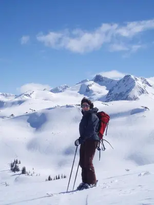 a person on skis standing on a snow covered mountain at Belle Neige Whistler in Whistler