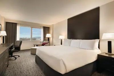 a hotel room with a large bed and a desk at Radisson Hotel Vancouver Airport in Richmond