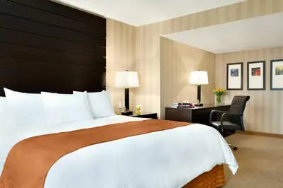 a hotel room with a large bed and a desk at Radisson Hotel Vancouver Airport in Richmond