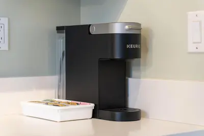 a black coffee machine with a box on a counter at Best Location Downtown Chic Suites in Vancouver