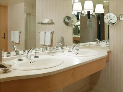 a bathroom with two sinks and a large mirror at Pan Pacific Vancouver in Vancouver