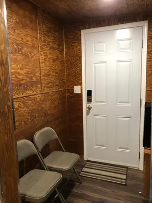 a room with two chairs and a white door at Shady Willow Guest House - SMALL Indipendent Units with Seperate Entrance for Travellers in Chilliwack