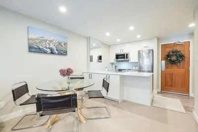 a kitchen and dining room with a table and chairs at The Aspens by Outpost Whistler in Whistler