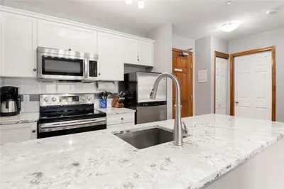 a kitchen with a sink and a counter top at The Aspens by Outpost Whistler in Whistler