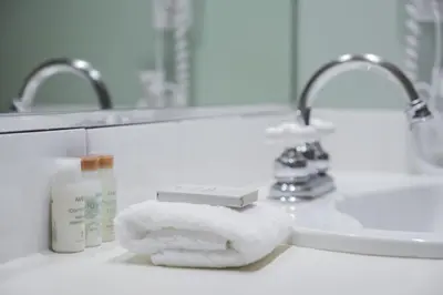 a pile of towels sitting on a bathroom counter next to a sink at The Aspens by Outpost Whistler in Whistler
