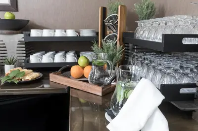 a buffet with wine glasses and fruit on a table at The Crystal Lodge in Whistler