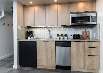 a kitchen with a stove and a microwave at The Crystal Lodge in Whistler