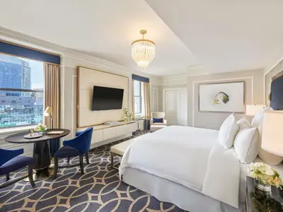 a hotel room with a large bed and a tv at Fairmont Hotel Vancouver in Vancouver